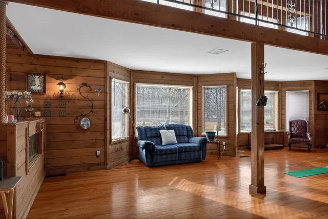 a living room with furniture and large windows