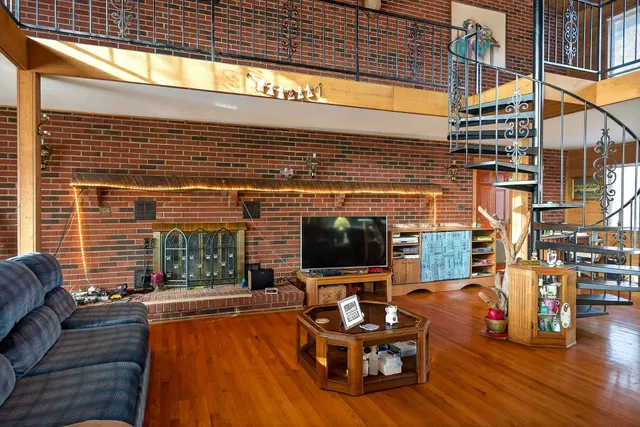 a living room with patio furniture and a flat screen tv