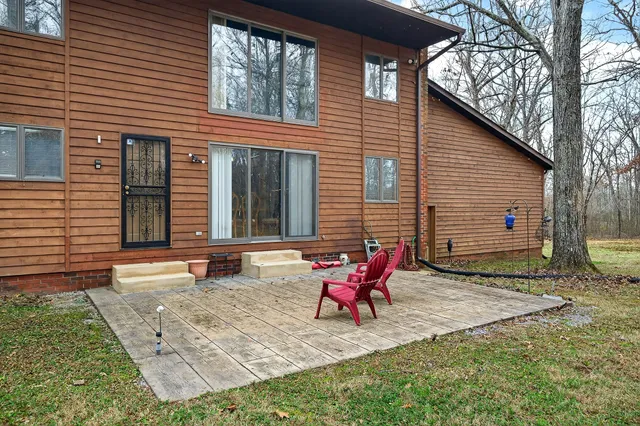 a view of a house with backyard and sitting area