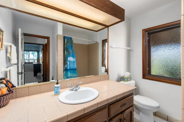 a bedroom with a bed and large windows