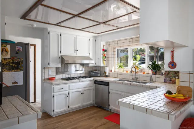 a kitchen with a sink stove and cabinets