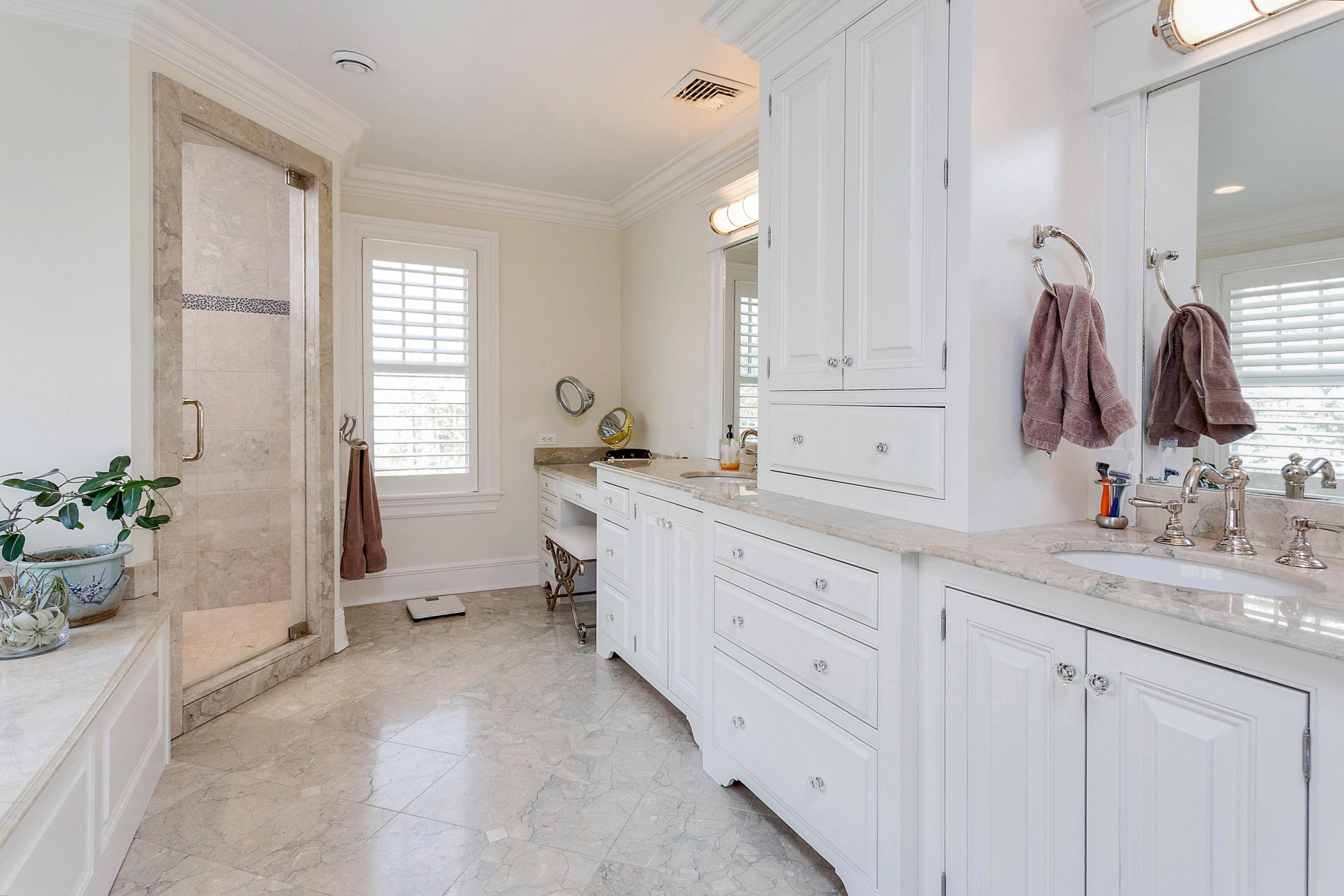 5 Old Parish Road Darien, CT 06820 - Photo 26 of 40 a spacious bathroom with a granite countertop sink a mirror and a bathtub