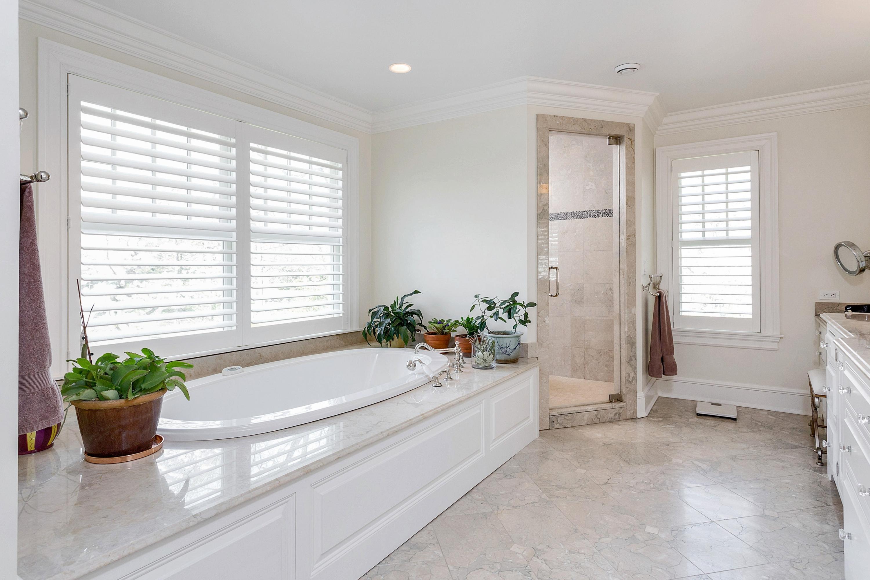 5 Old Parish Road Darien, CT 06820 - Photo 27 of 40 a bathroom with a tub a potted plant and a window