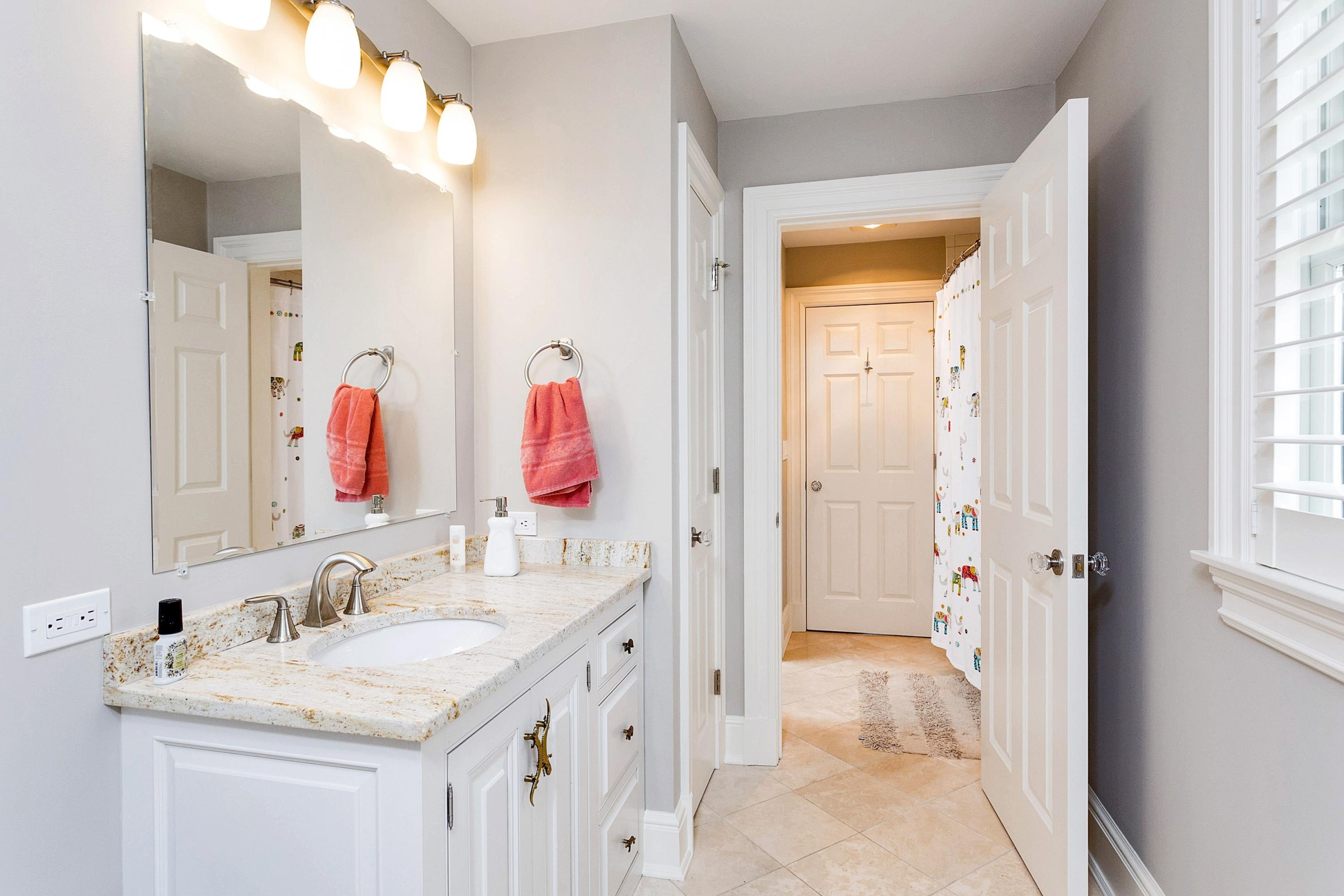 5 Old Parish Road Darien, CT 06820 - Photo 32 of 40 a bathroom with a granite countertop sink vanity and a mirror