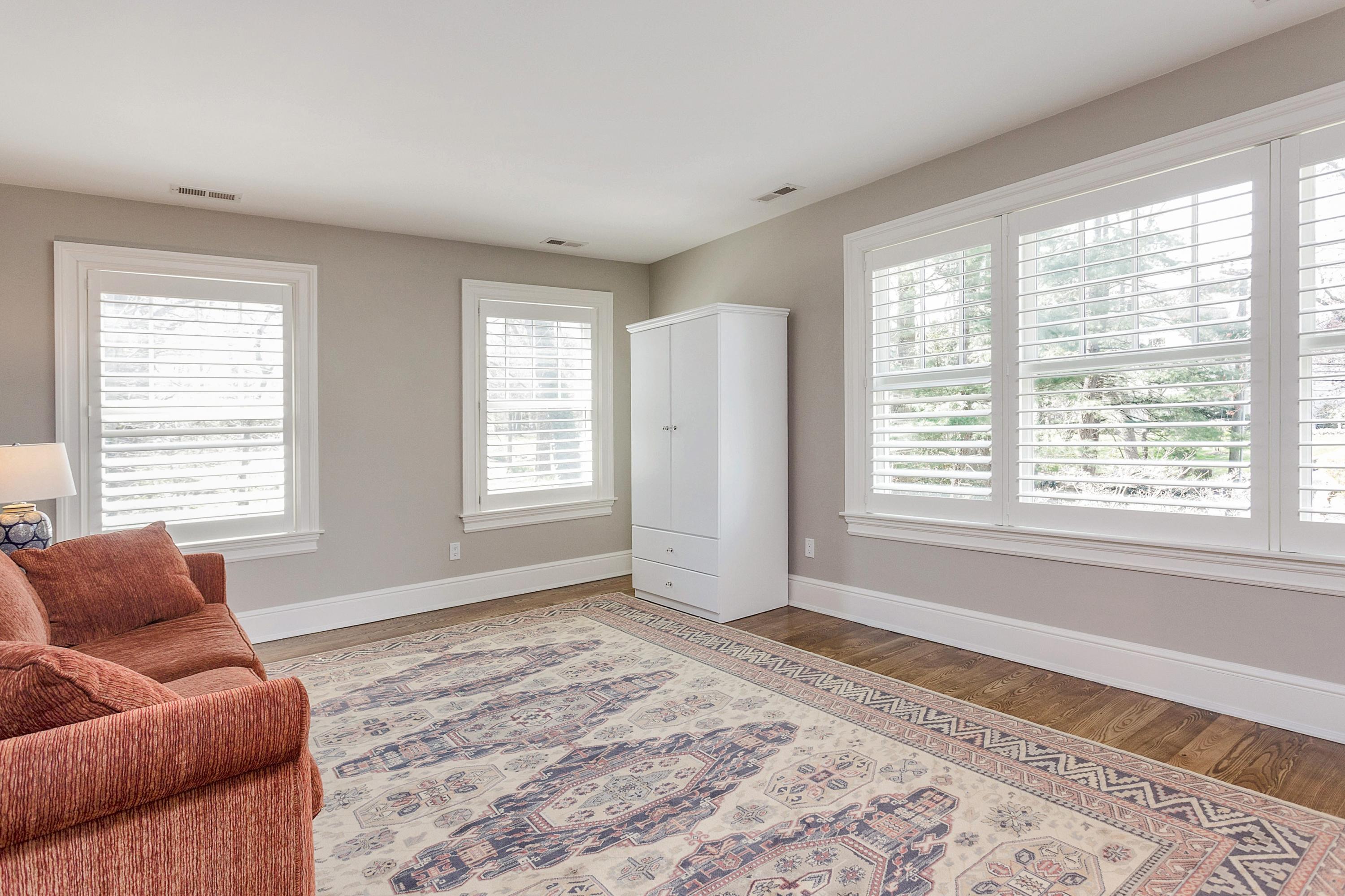 5 Old Parish Road Darien, CT 06820 - Photo 33 of 40 a living room with a couch and a dresser next to a window
