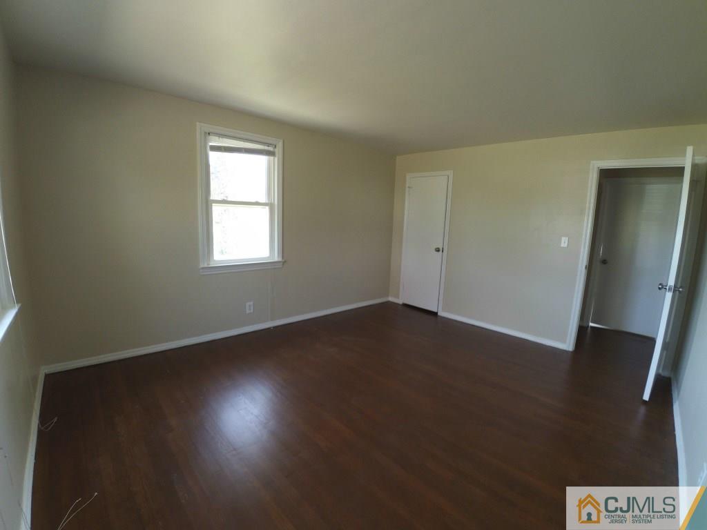 791 Hermann Road North Brunswick, NJ 08902 - Photo 3 of 14 an empty room with wooden floor and windows