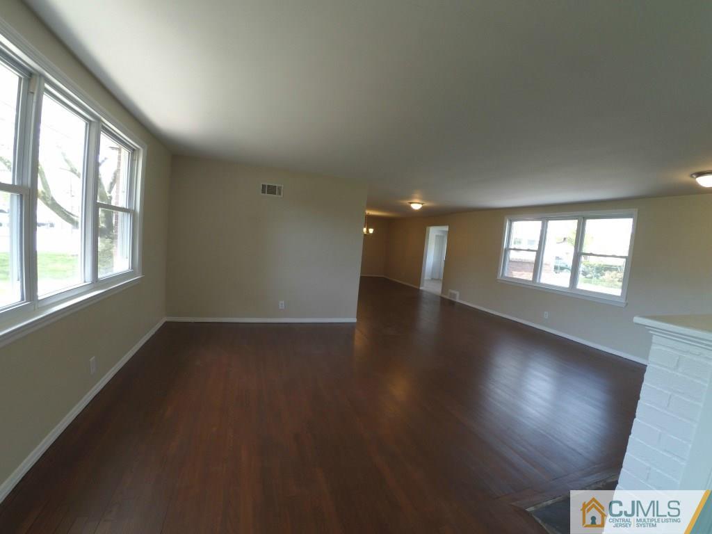 791 Hermann Road North Brunswick, NJ 08902 - Photo 4 of 14 an empty room with wooden floor and windows