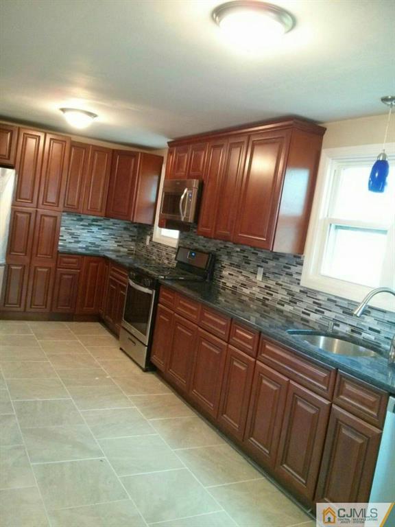 791 Hermann Road North Brunswick, NJ 08902 - Photo 5 of 14 a kitchen with granite countertop wooden cabinets a sink and a counter top space