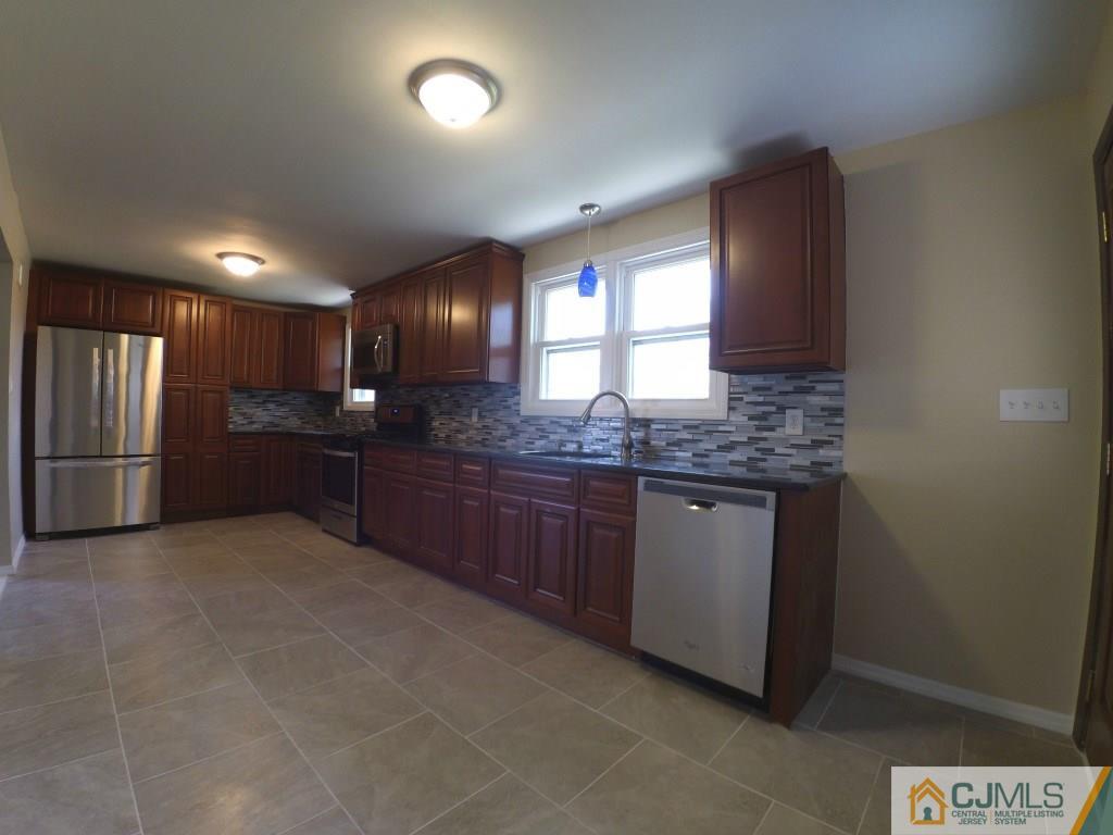791 Hermann Road North Brunswick, NJ 08902 - Photo 6 of 14 a kitchen with stainless steel appliances granite countertop a refrigerator and a stove top oven