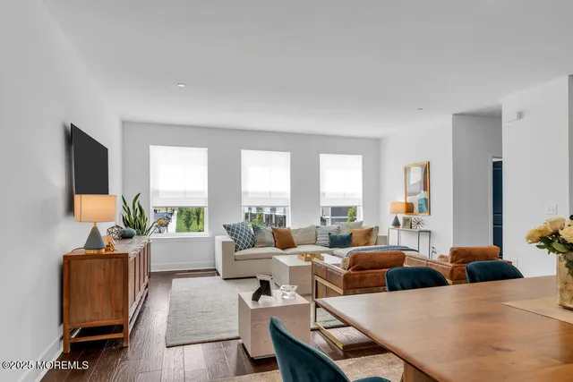 a kitchen with granite countertop white cabinets stainless steel appliances and a sink