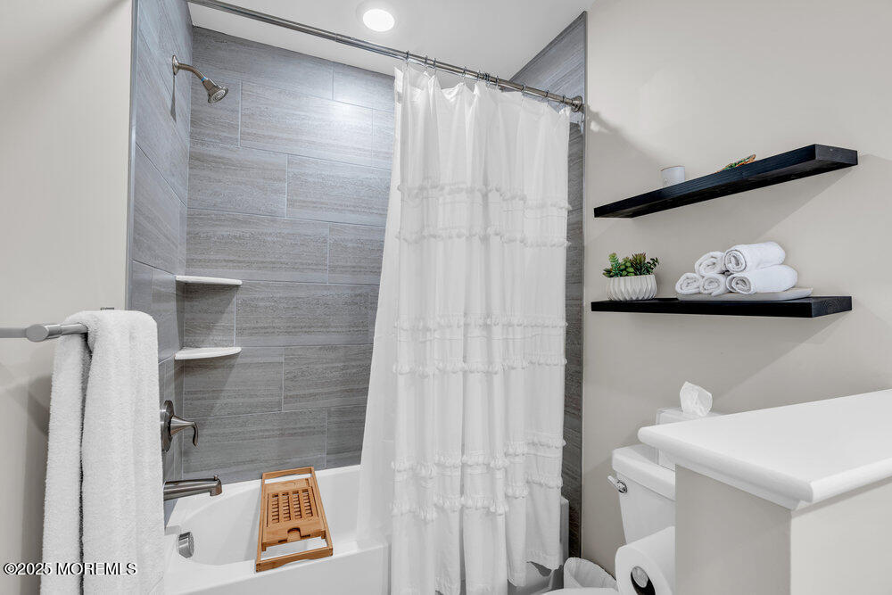 63 Bataan Avenue Tinton Falls, NJ 07724 - Photo 43 of 64 a bathroom with a shower and toilet
