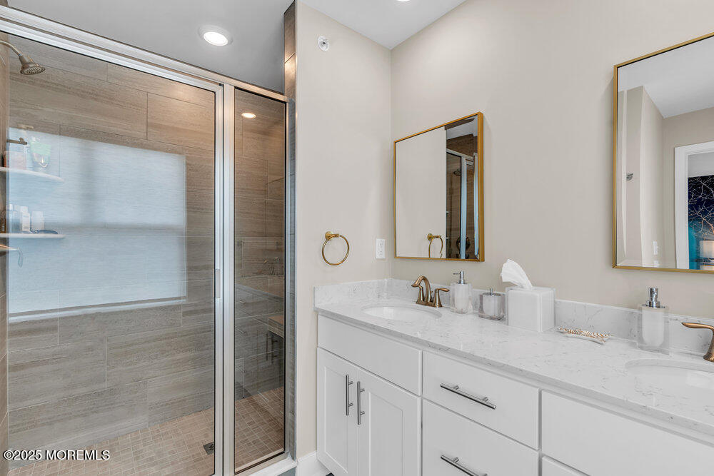 63 Bataan Avenue Tinton Falls, NJ 07724 - Photo 48 of 64 a bathroom with a double vanity sink mirror and shower