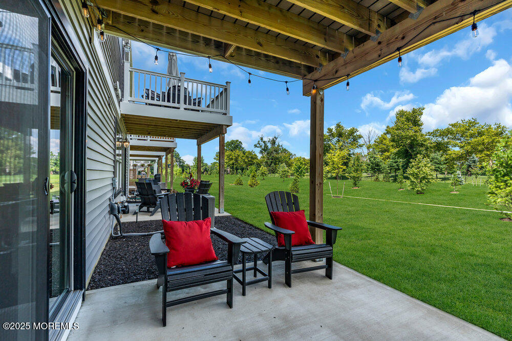 63 Bataan Avenue Tinton Falls, NJ 07724 - Photo 50 of 64 a view of a two chairs in the patio next to a yard