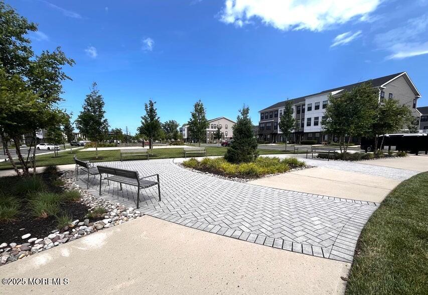 63 Bataan Avenue Tinton Falls, NJ 07724 - Photo 58 of 64 a view of a lake with a house in the background
