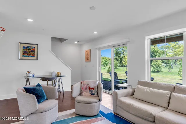 a living room with furniture rug and window