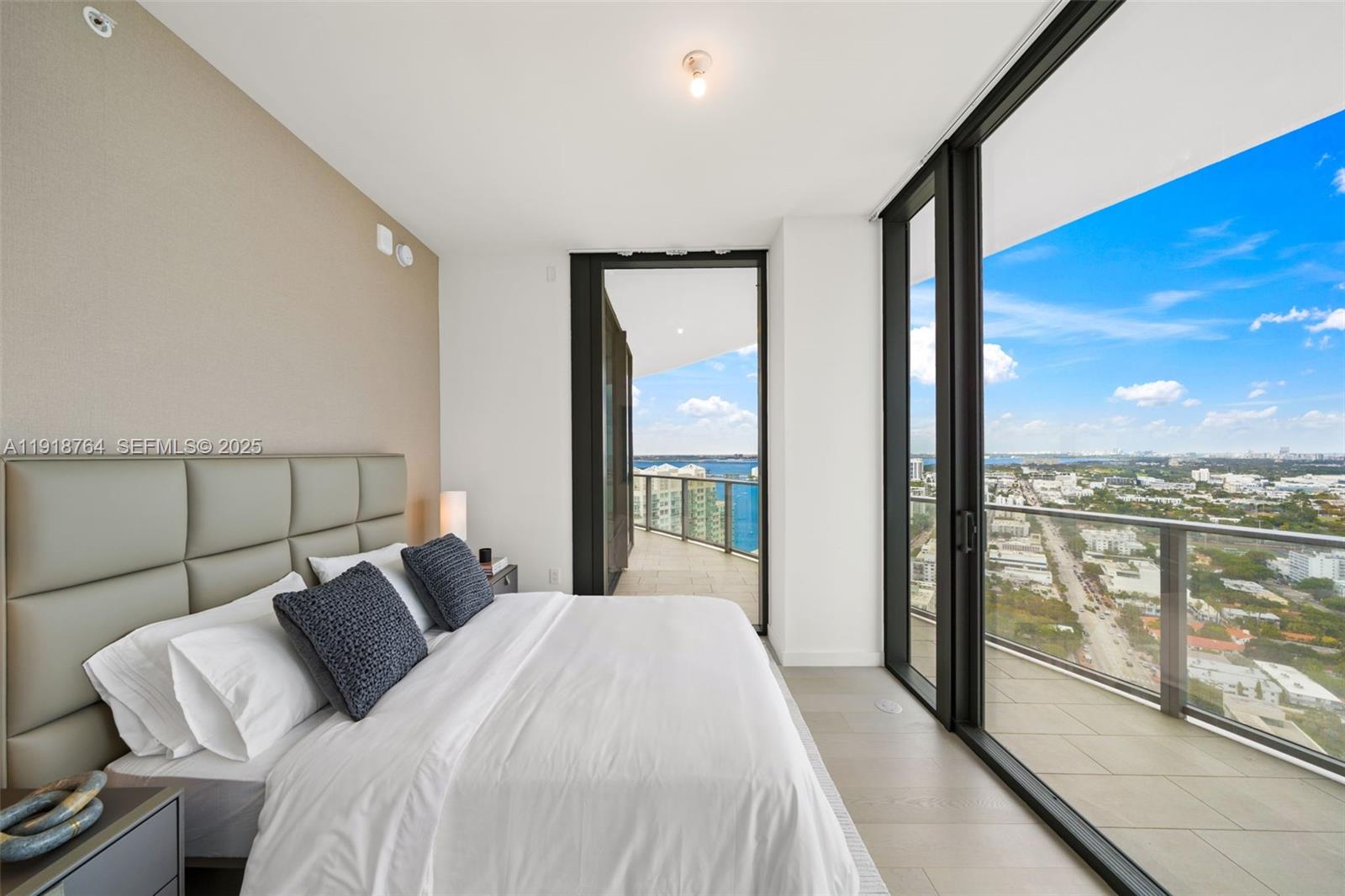 500 Alton Road, Unit 3402 03 Miami Beach, FL 33139 - Photo 16 of 77 a bedroom with a large bed and a large window with outer view