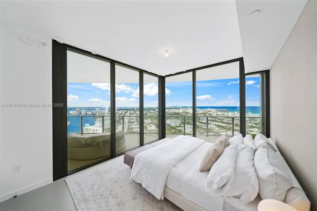 a living room with furniture and floor to ceiling windows