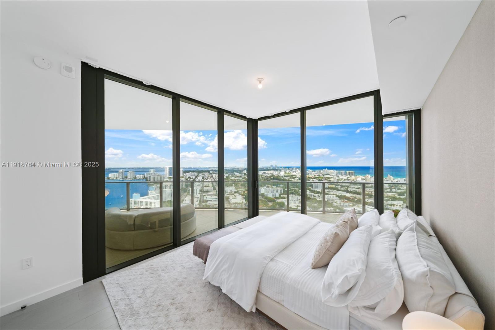 500 Alton Road, Unit 3402 03 Miami Beach, FL 33139 - Photo 21 of 77 a bed sitting in a bedroom next to a window