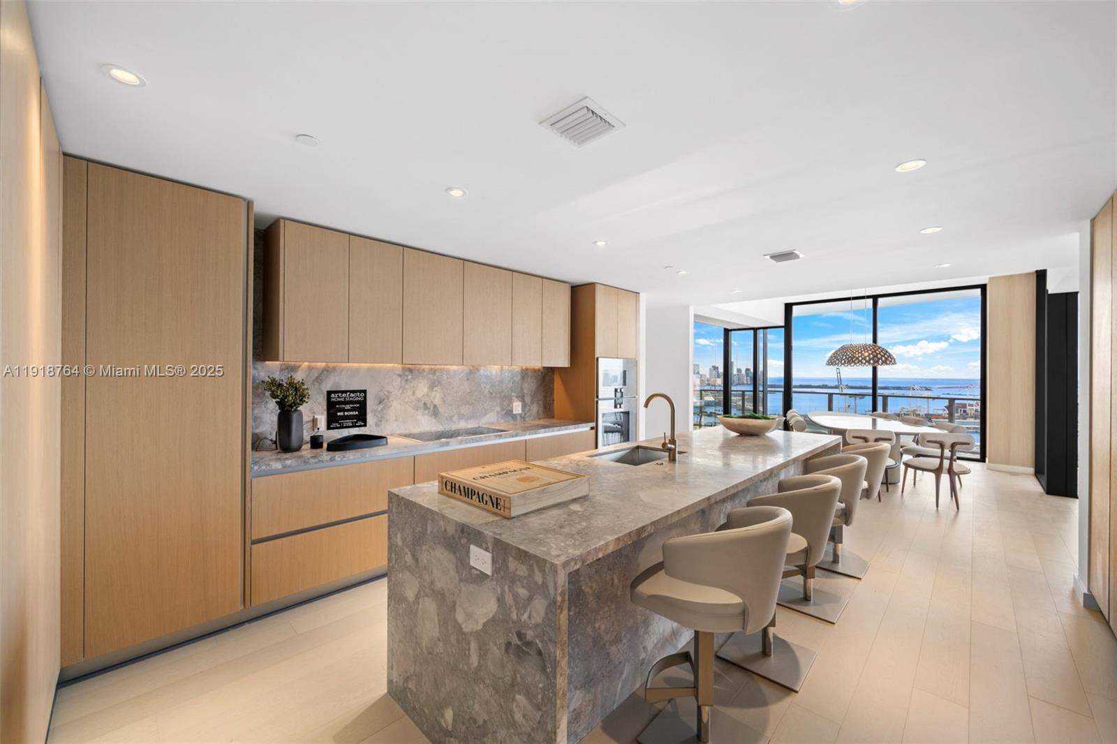 500 Alton Road, Unit 3402 03 Miami Beach, FL 33139 - Photo 39 of 77 a view of a kitchen with kitchen island a large counter top space a sink stainless steel appliances and cabinets