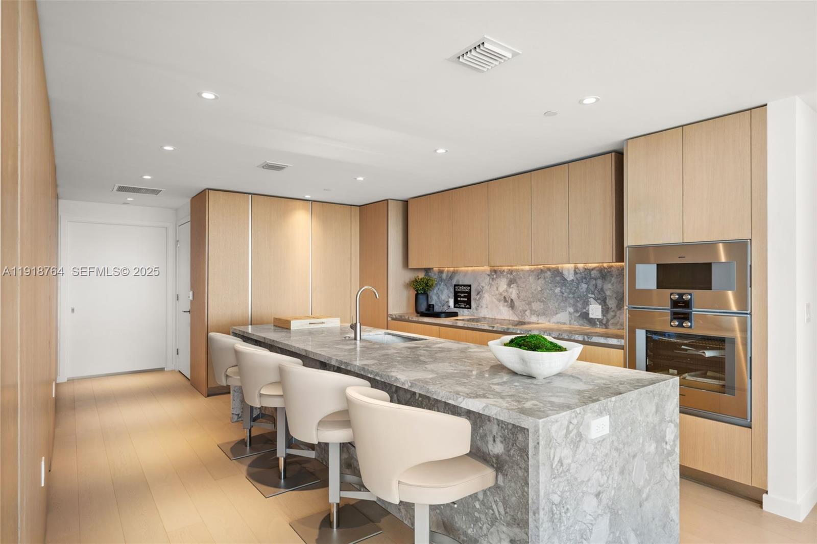500 Alton Road, Unit 3402 03 Miami Beach, FL 33139 - Photo 42 of 77 a kitchen with a sink and chairs
