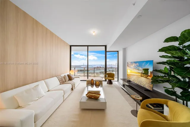a view of a hallway with toilet and wooden floor