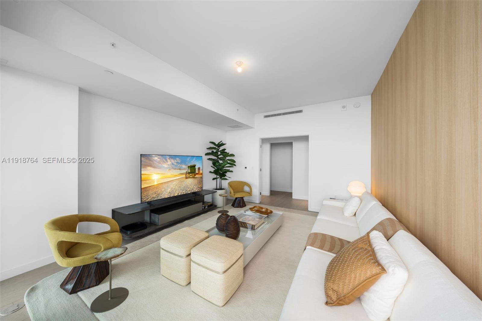 500 Alton Road, Unit 3402 03 Miami Beach, FL 33139 - Photo 50 of 77 a living room with furniture and a flat screen tv