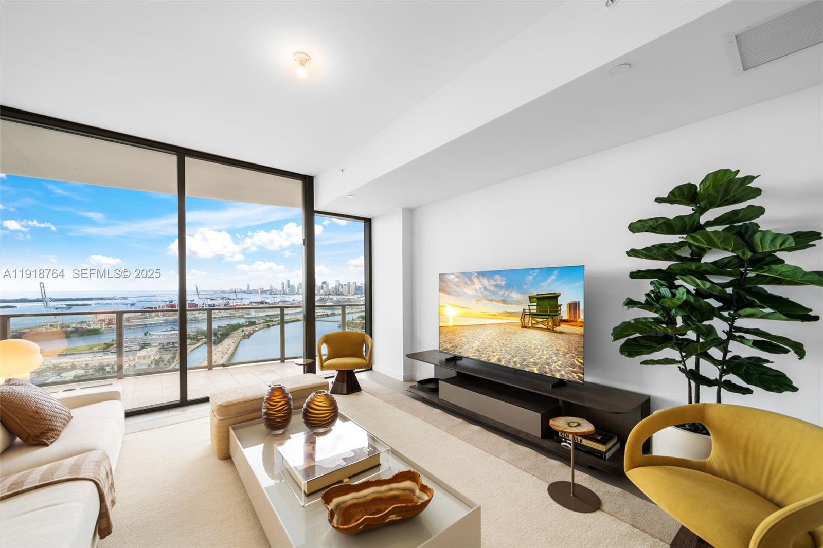 500 Alton Road, Unit 3402 03 Miami Beach, FL 33139 - Photo 51 of 77 a living room with furniture and a flat screen tv