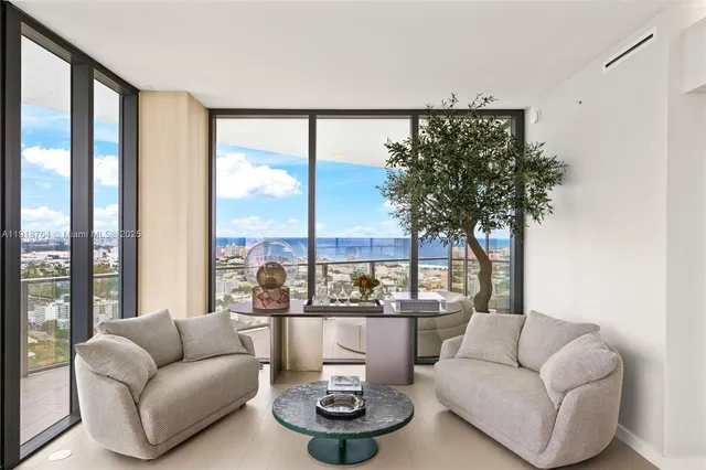 a bedroom with a large bed and a large window with outer view