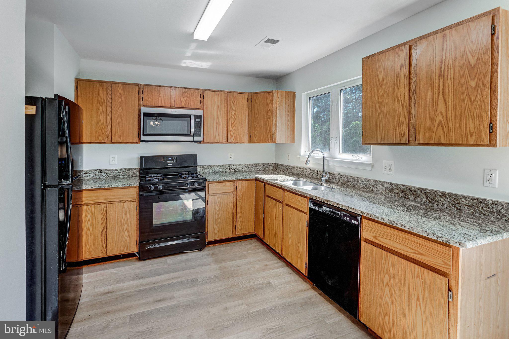 6489 McCoy Road Centreville, VA 20121 - Photo 10 of 34 Modern kitchen with warm wood accents.