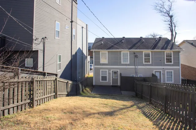 a view of a house with wooden fence