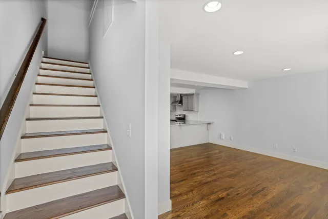 a view of entryway and hall with wooden floor