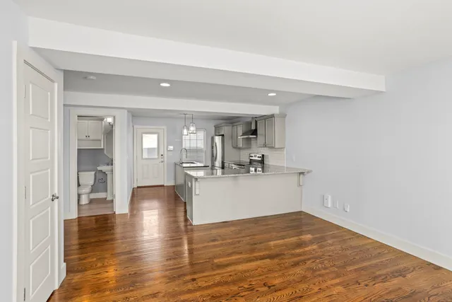 a view of a kitchen with wooden floor