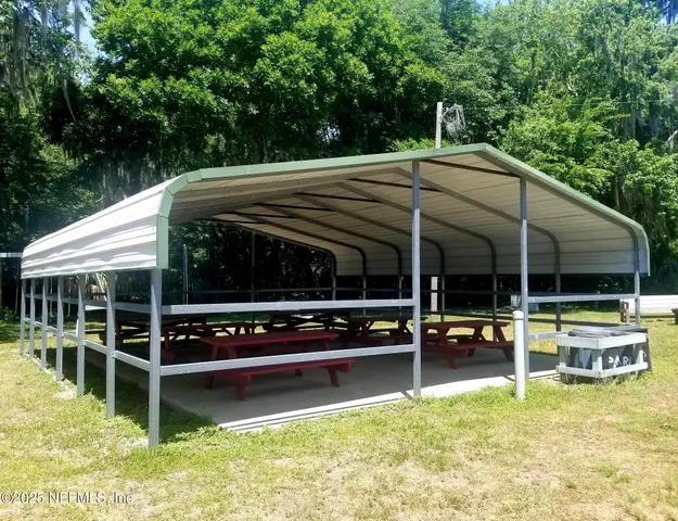 a view of a backyard with a slide trees