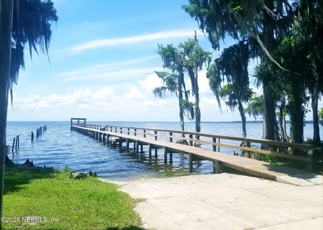 a view of a back yard with a bench