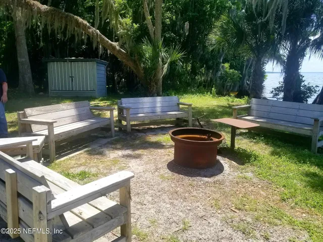 a view of a swimming pool with a table and chairs