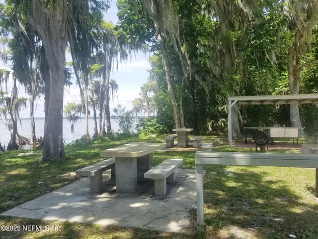 a view of house with swimming pool and sitting area