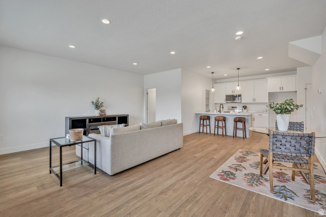 330 East 7635 S Street Sandy, UT 84047 - Photo 2 of 29 Living area featuring light wood finished floors and recessed lighting