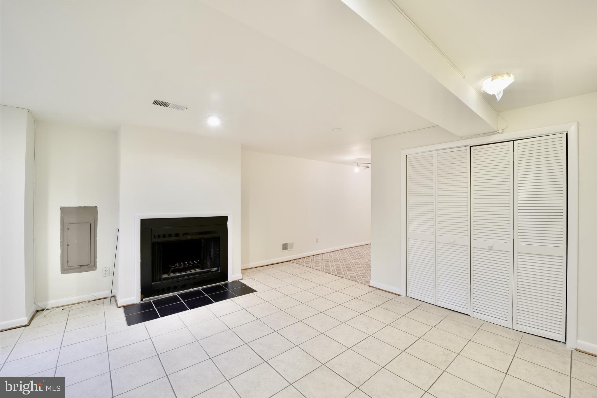 1926 15th Street Northwest, Unit 1 Washington, DC 20009 - Photo 3 of 13 a view of empty room with fireplace and tv