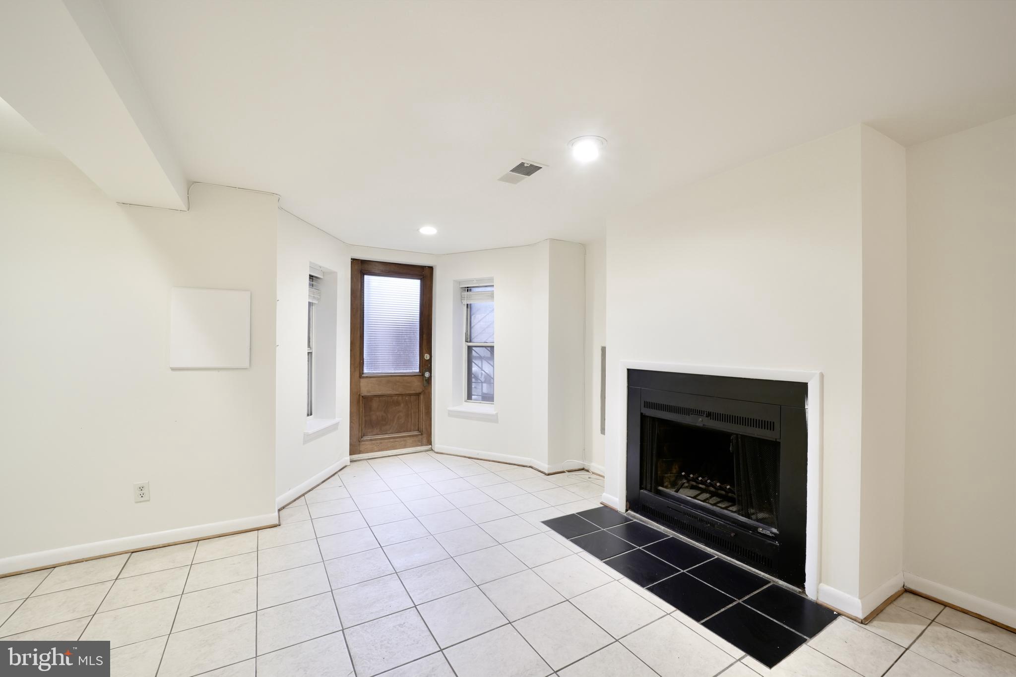 1926 15th Street Northwest, Unit 1 Washington, DC 20009 - Photo 5 of 13 a view of an empty room with a fireplace