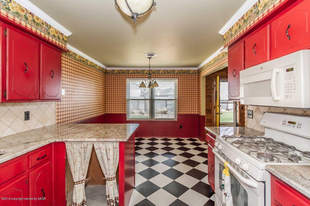5337 Whitney Lane Amarillo, TX 79110 - Photo 13 of 32 a kitchen with a stove a sink and a refrigerator