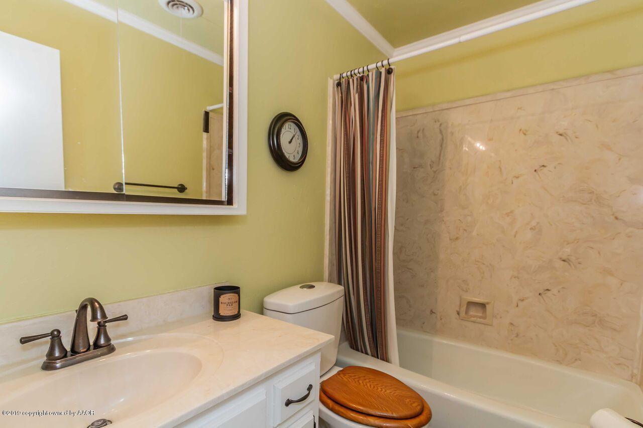 5337 Whitney Lane Amarillo, TX 79110 - Photo 21 of 32 a bathroom with a sink a toilet and shower