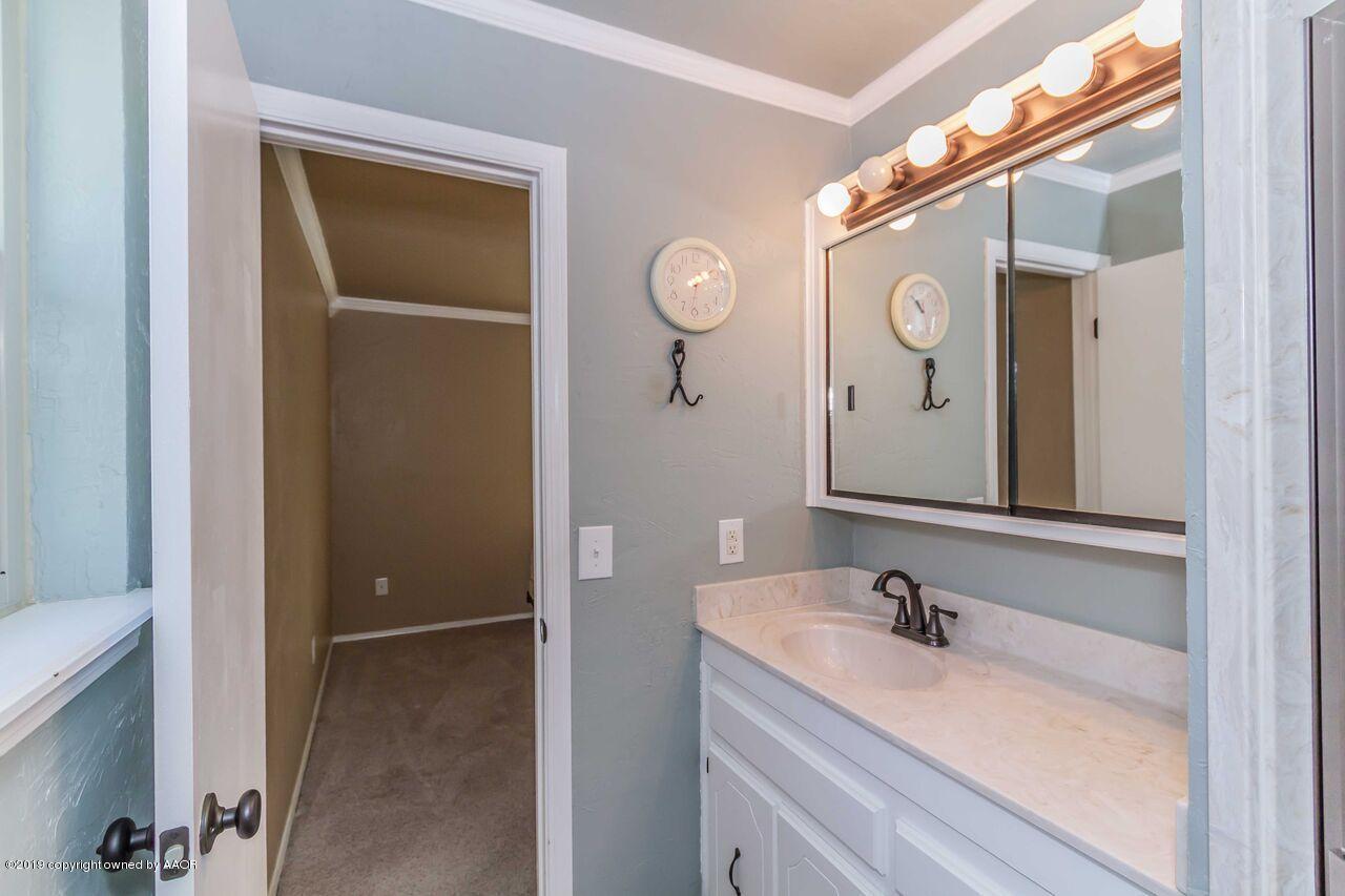 5337 Whitney Lane Amarillo, TX 79110 - Photo 32 of 32 a bathroom with a sink and a mirror