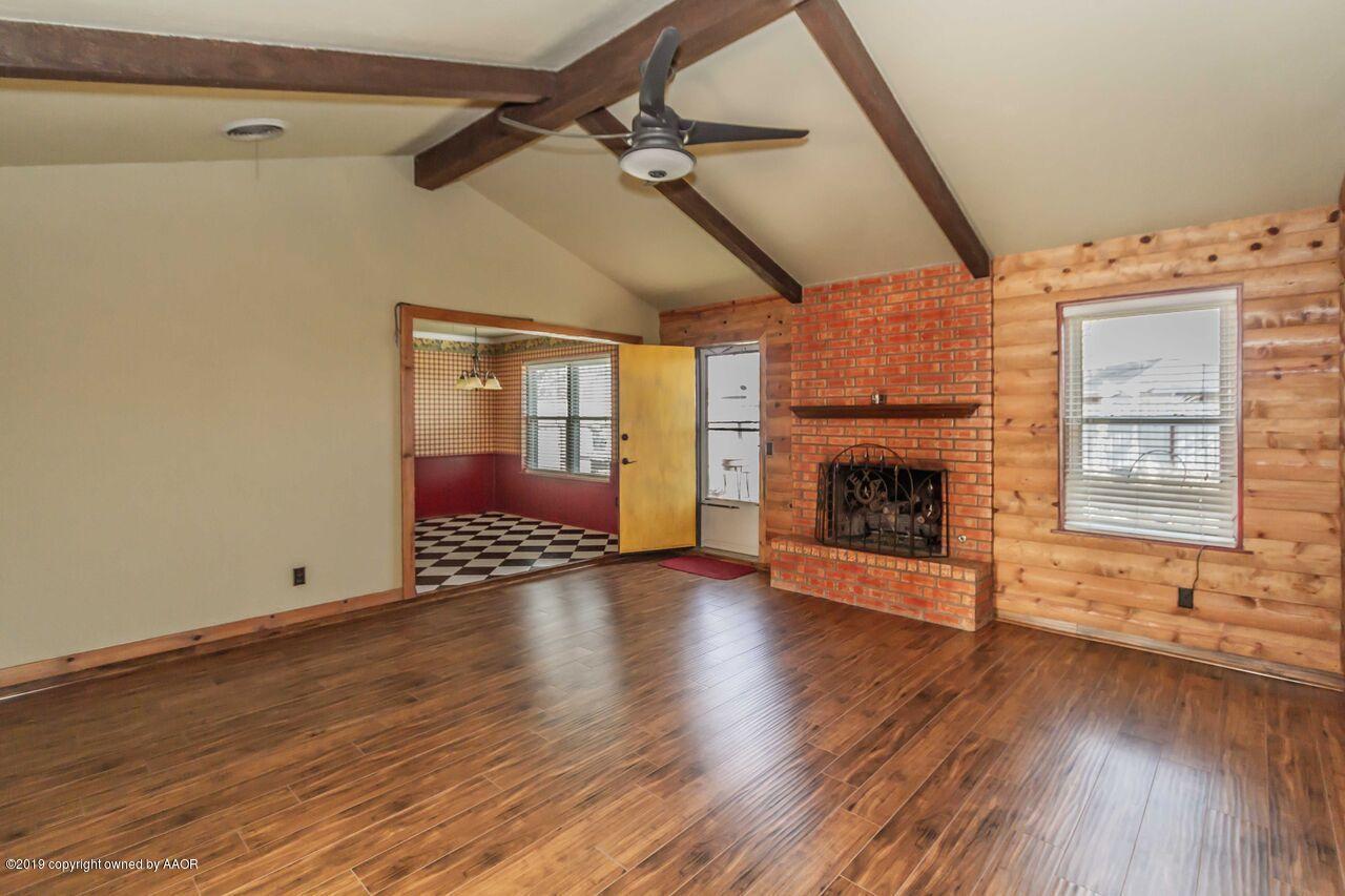 5337 Whitney Lane Amarillo, TX 79110 - Photo 10 of 32 a view of empty room with wooden floor and fireplace