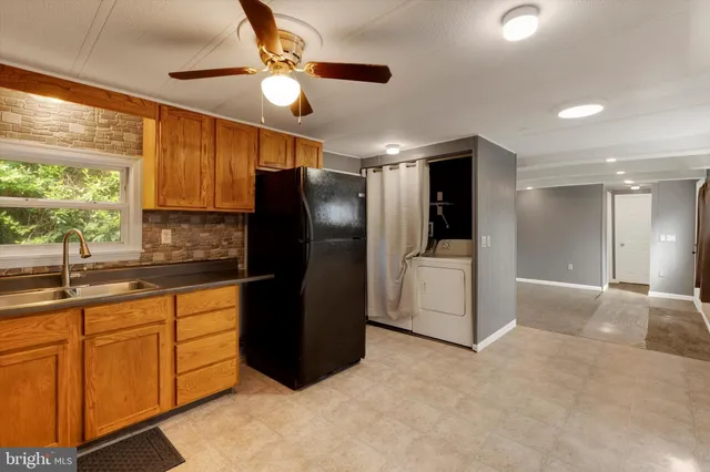 a kitchen with a refrigerator and a sink