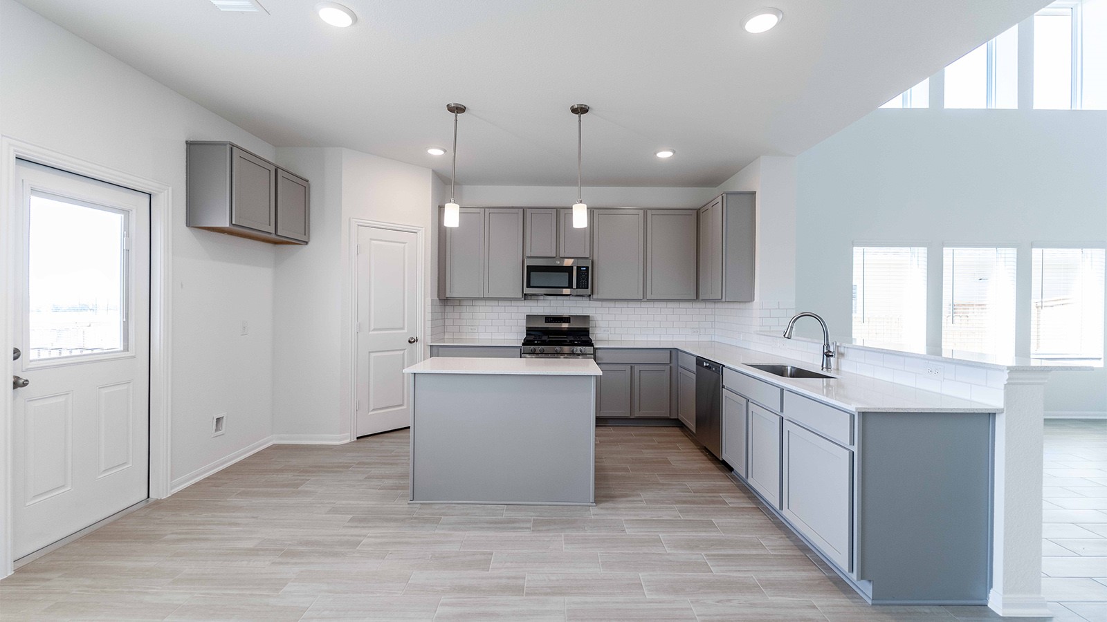 13621 Endless Narrow Lane Elgin, TX 78621 - Photo 15 of 19 a kitchen with stainless steel appliances granite countertop a sink stove and refrigerator