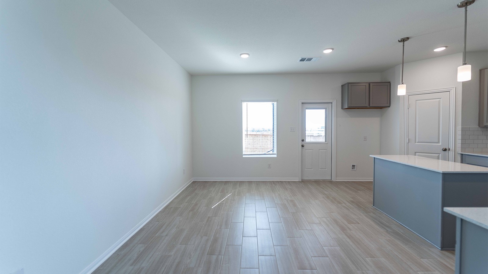 13621 Endless Narrow Lane Elgin, TX 78621 - Photo 7 of 19 a view of a kitchen with wooden floor and a sink