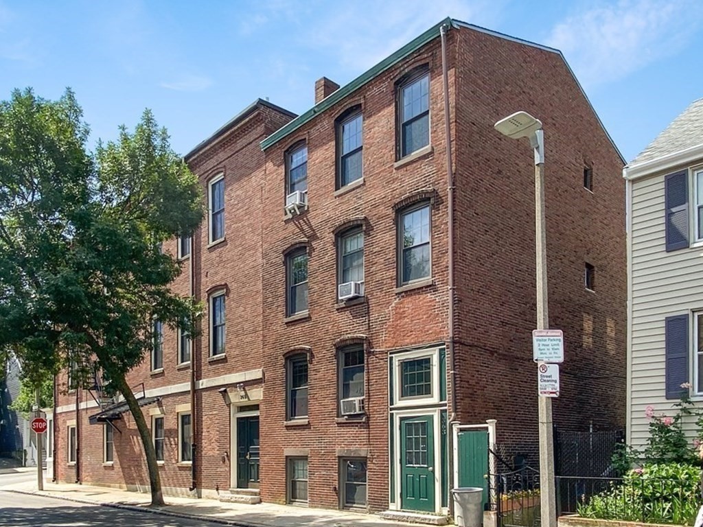 363 West 3rd Street, Unit 1 Boston, MA 02127 - Photo 1 of 12 a front view of a building with a yard