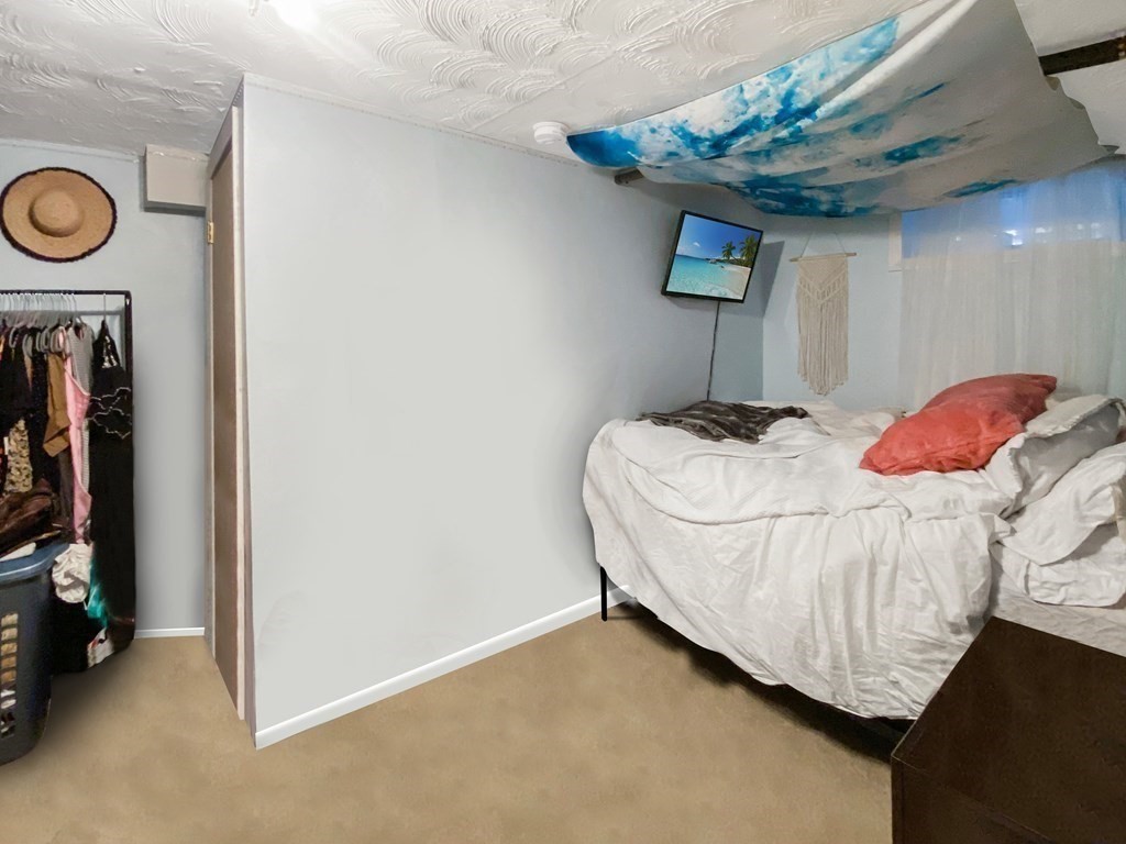 363 West 3rd Street, Unit 1 Boston, MA 02127 - Photo 11 of 12 a bedroom with a bed and a chandelier