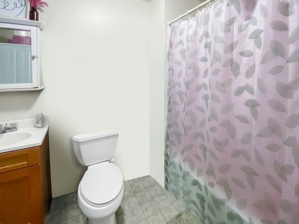 363 West 3rd Street, Unit 1 Boston, MA 02127 - Photo 8 of 12 a white toilet sitting next to a shower curtain