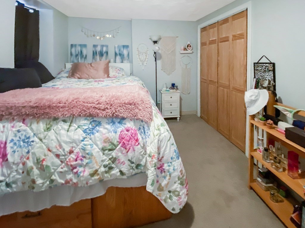 363 West 3rd Street, Unit 1 Boston, MA 02127 - Photo 10 of 12 a bedroom with a bed and a chandelier